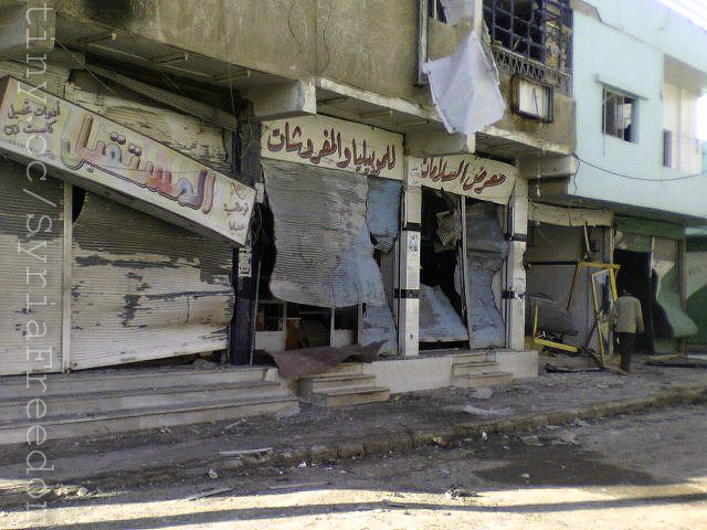 the remains of a run down building on a street