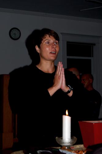 a man who is standing in front of a candle