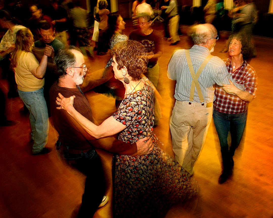 a group of people dancing in a crowded room