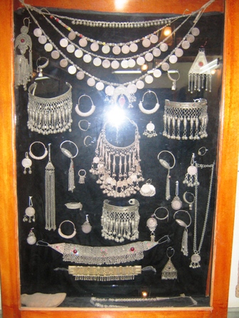 a display case containing necklaces and other accessories