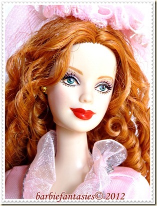 a barbie with red hair wearing a pink dress