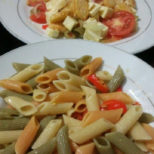 a bowl of pasta and another dish on a table