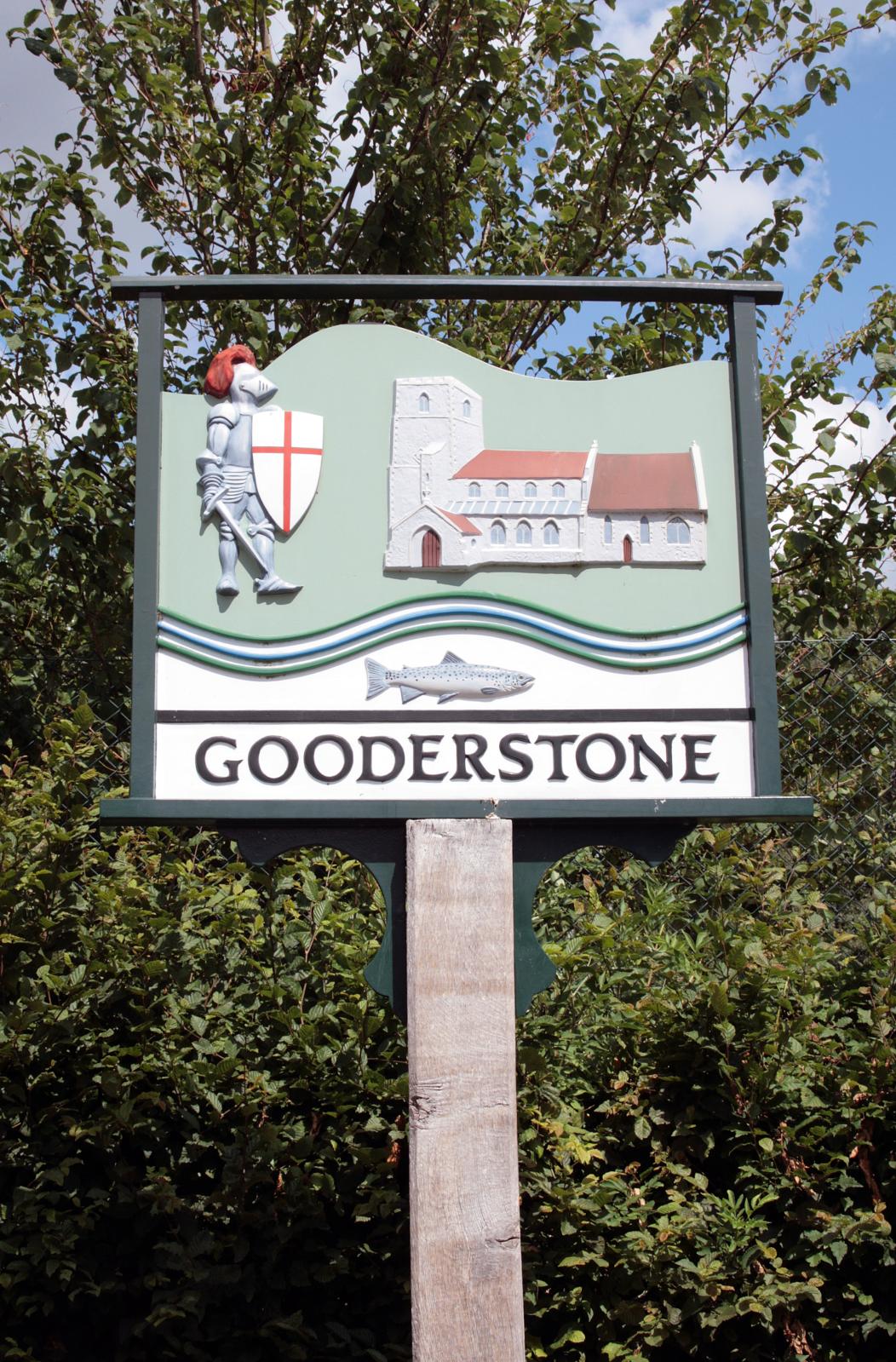 the gooderstone sign is displayed in front of a grove of trees