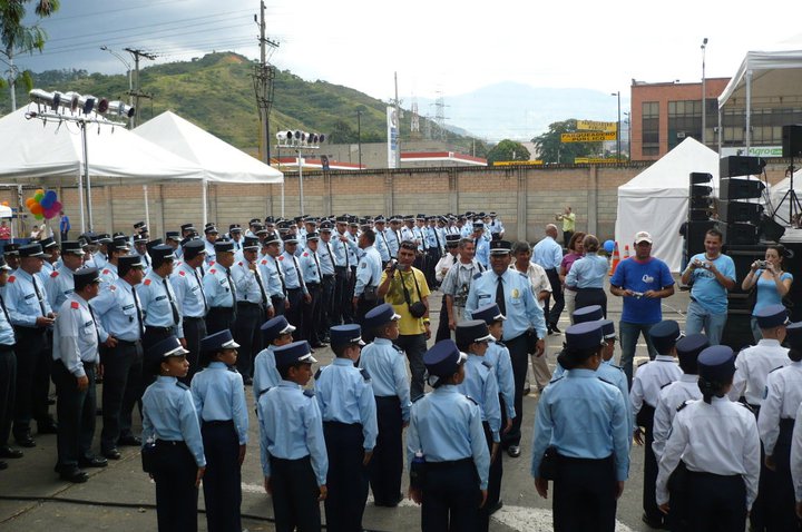 several people standing in a row, some wearing blue uniforms