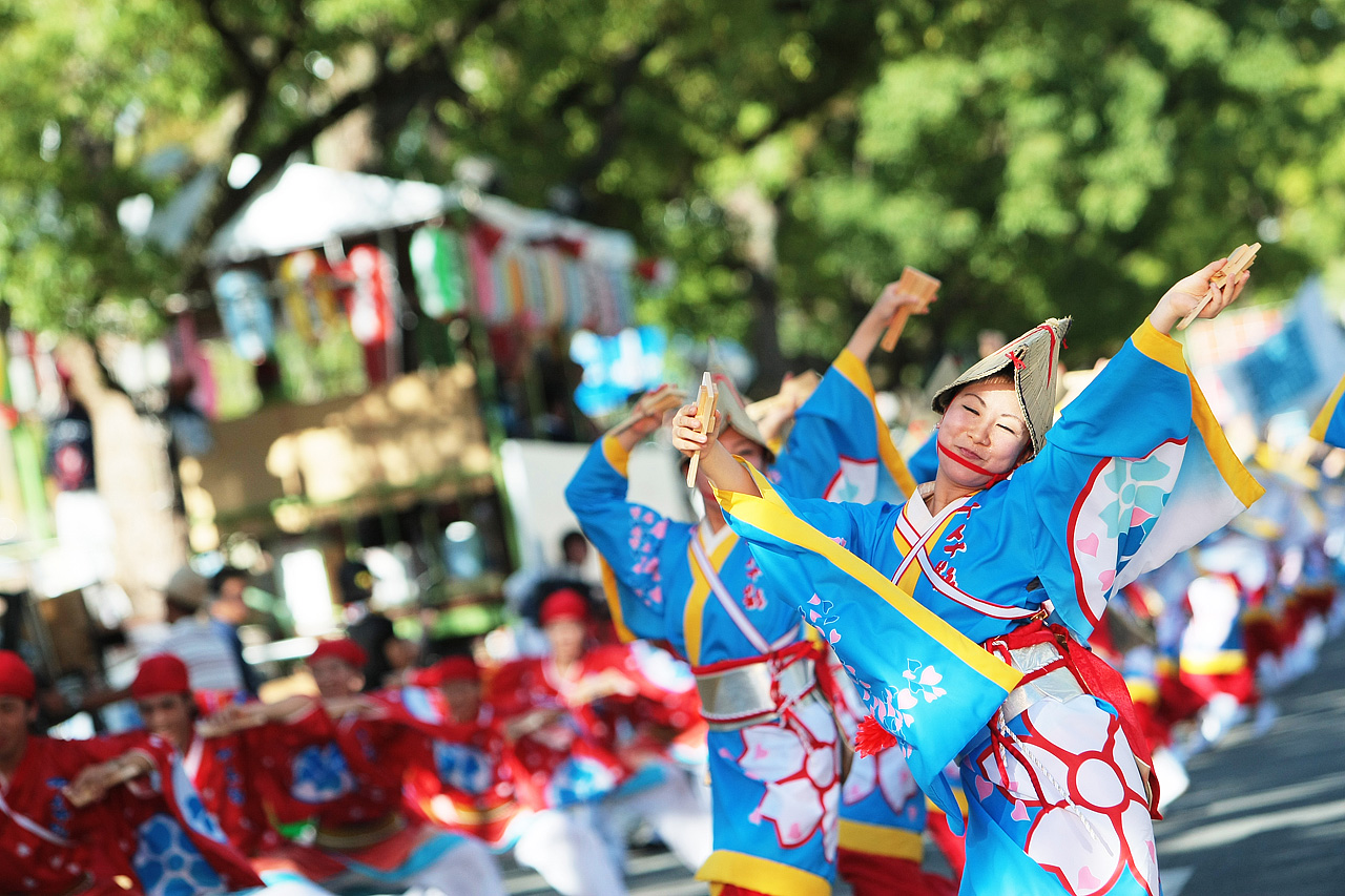 performers from the street perform in colorful costumes