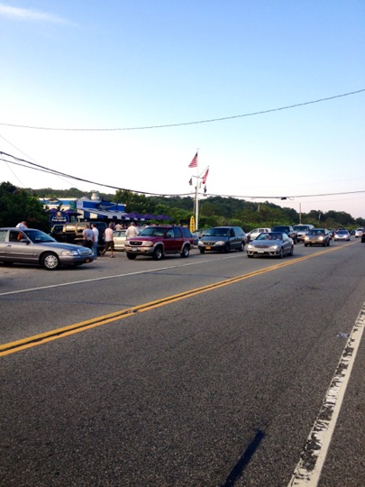 many cars that are lined up on the side of the road