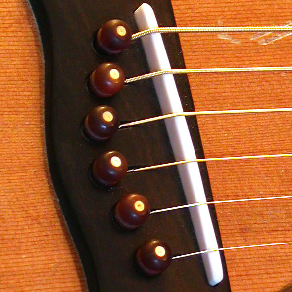 a string guitar with chocolate candies on it