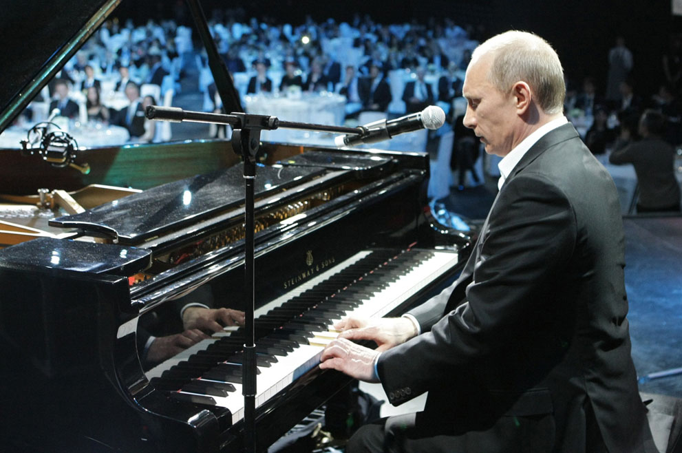 man playing piano in front of an audience