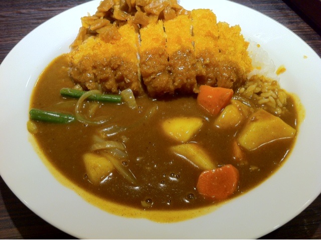 a plate filled with soup and vegetables and bread