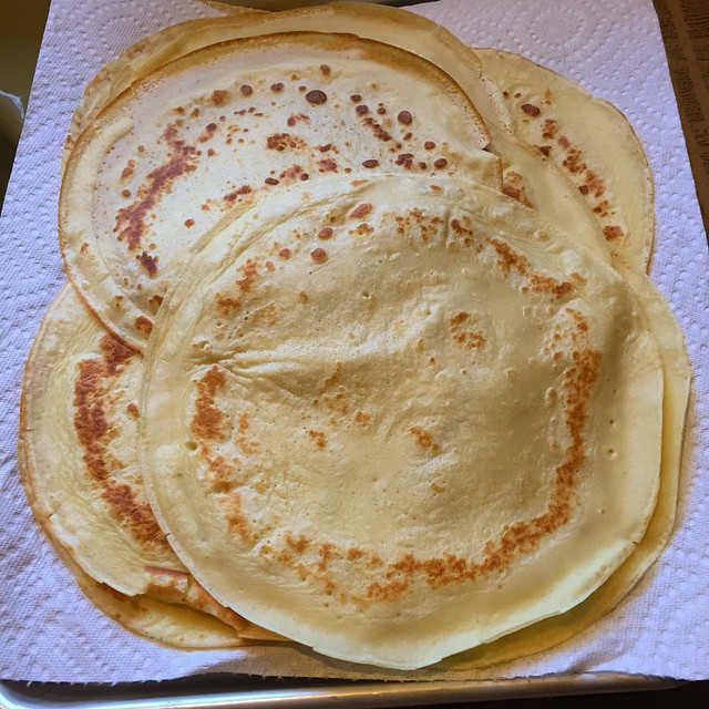 a pan filled with cooked pancakes sitting on top of a cloth