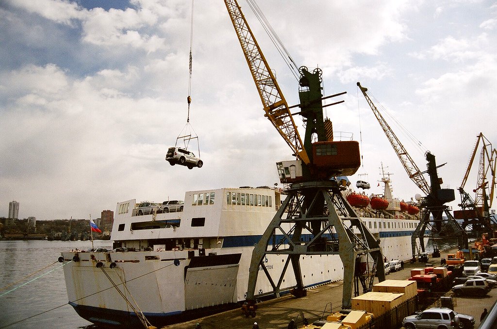 two big ships that are sitting by the water