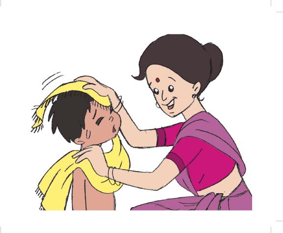 a woman drying her hair while sitting next to a child