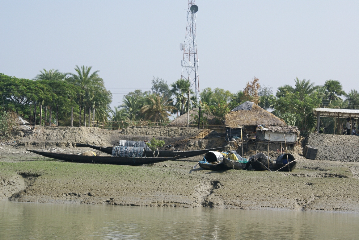 two boats tied to the side of a river