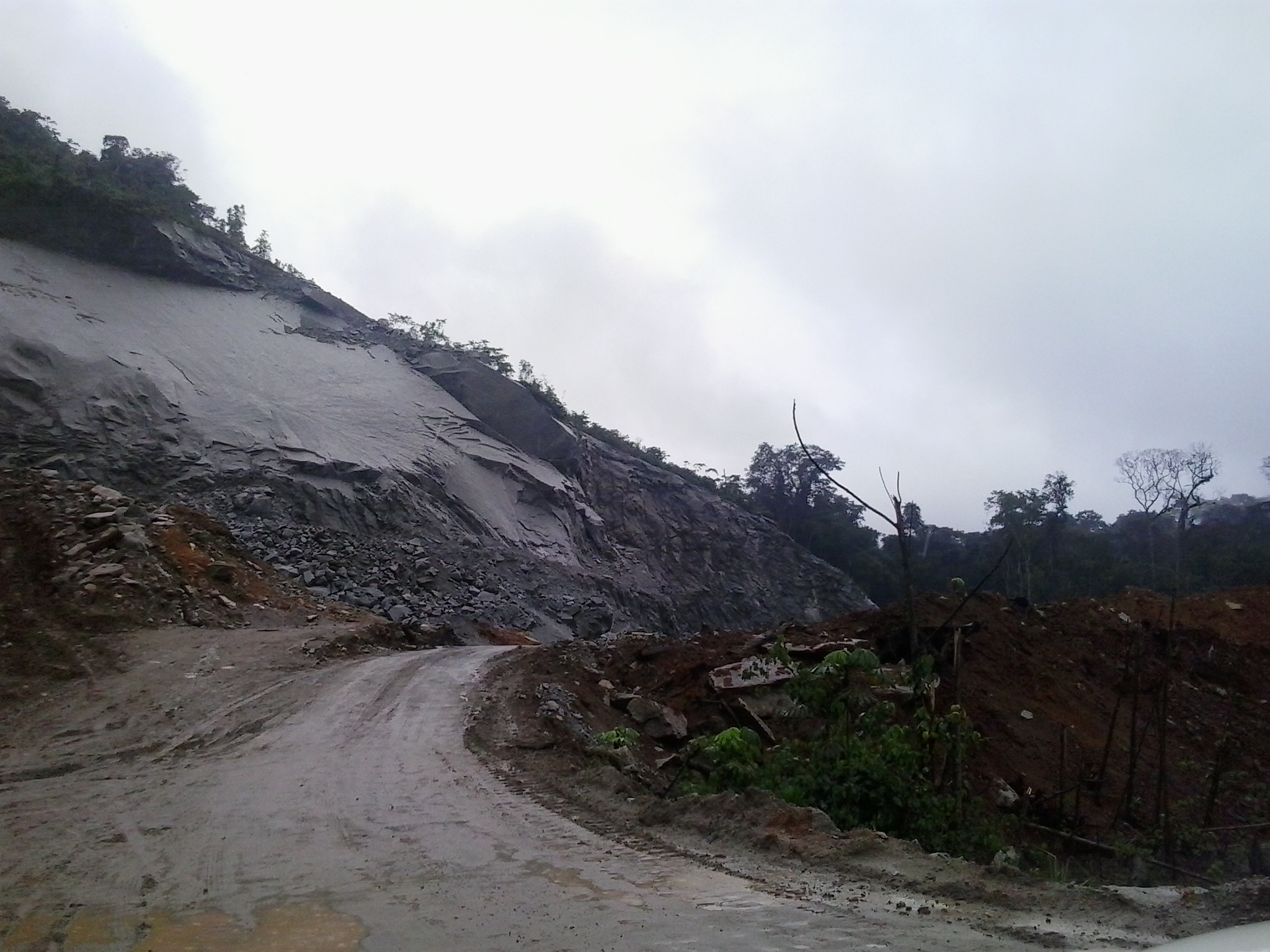 the road is covered with mud from a large cliff
