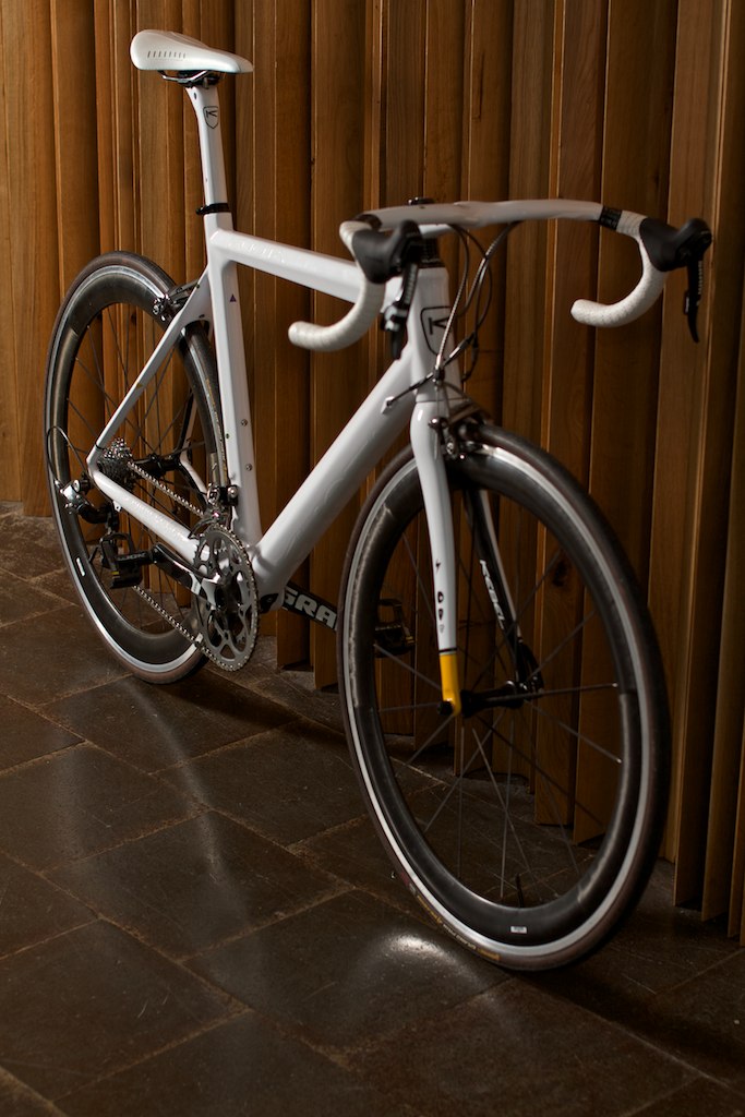 a bicycle in front of a wooden wall