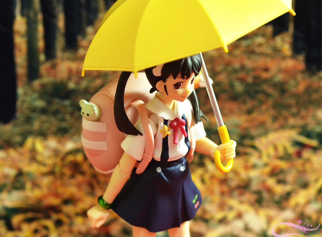 the girl is wearing a school uniform and holding a yellow umbrella