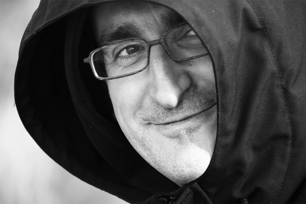 black and white po of man wearing a hoodie