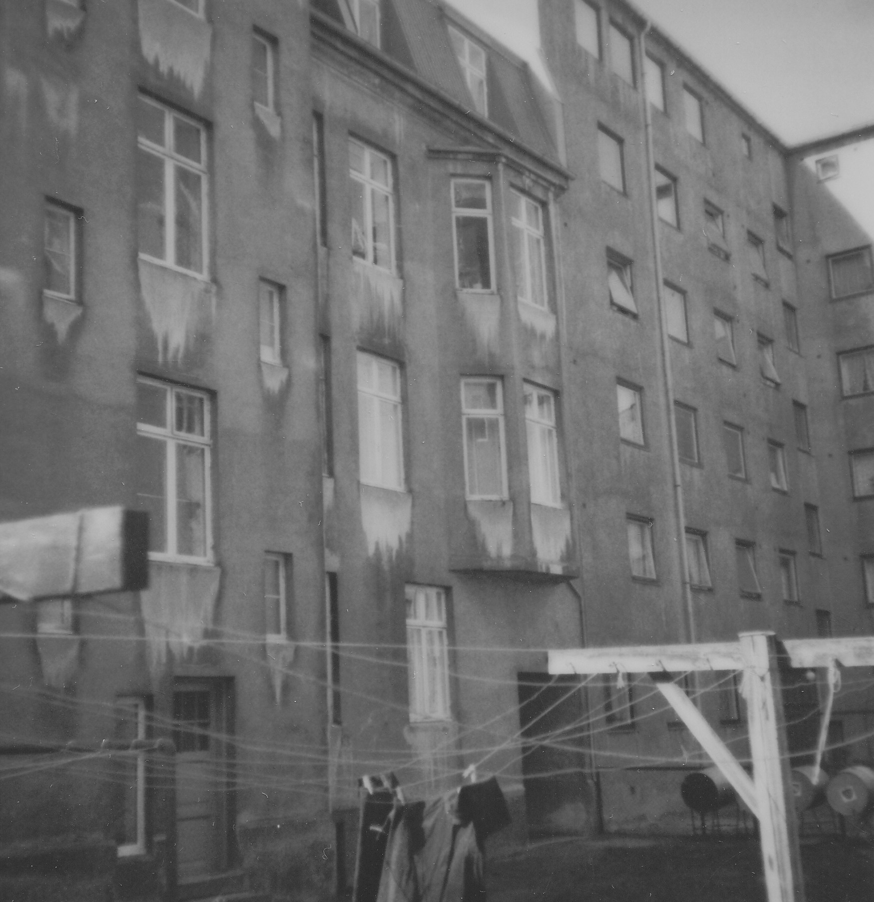 two old buildings near each other and some clothes hanging from a line