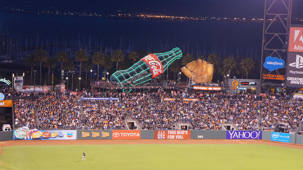 a baseball field with many fans at night