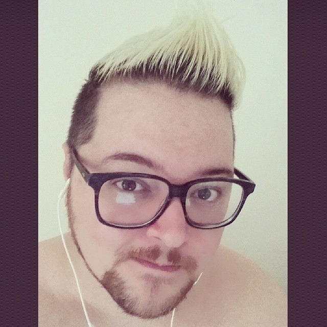 an image of man with glasses and punk punk rocker hairs