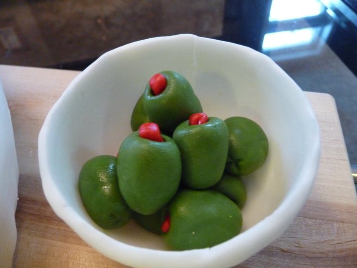 there is a white bowl filled with green peppers