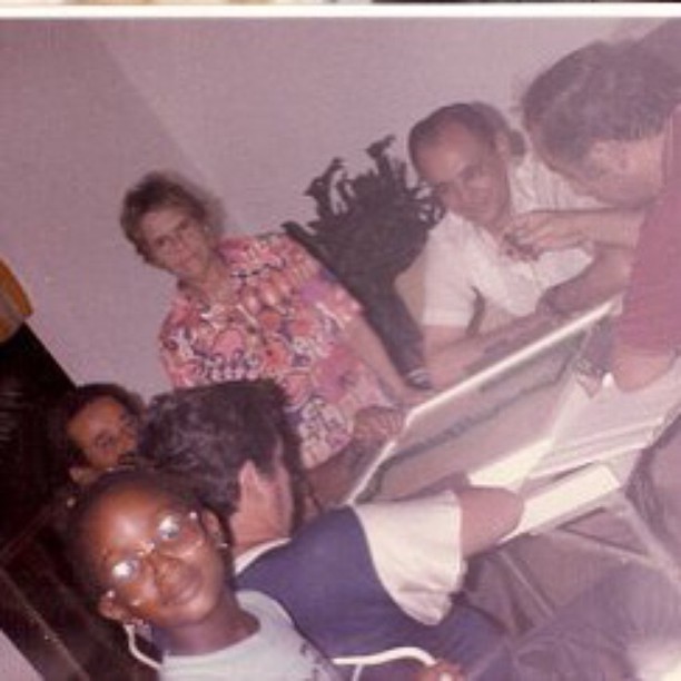 a group of people who are sitting in front of a computer