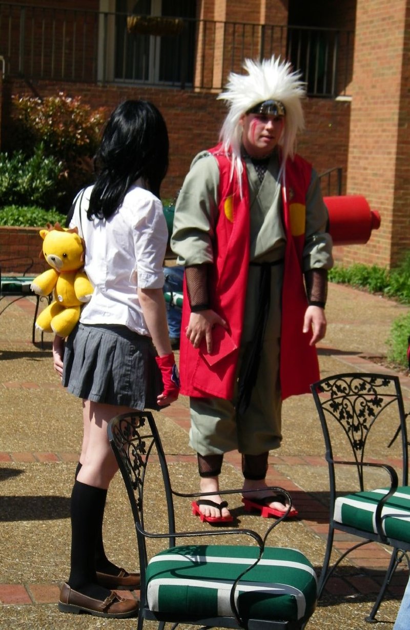 two people in costumes on a patio chair