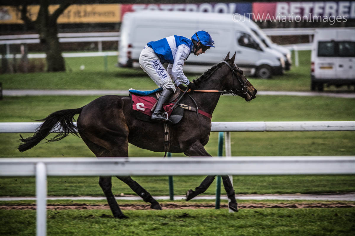 a jockey is running a horse on the track