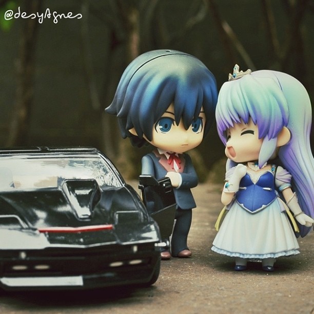 a car is next to a couple figurines