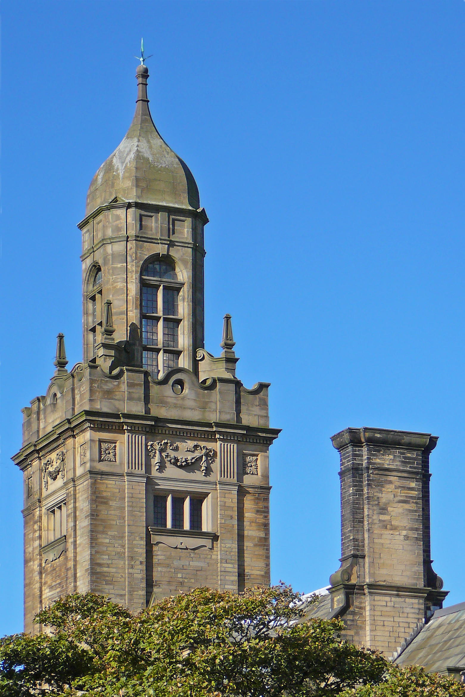 an old, tall building with a clock on it's face