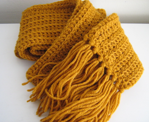 an orange scarf on a white table