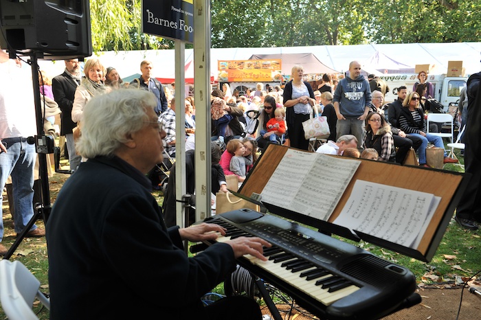 woman playing an organ outside at a music festival