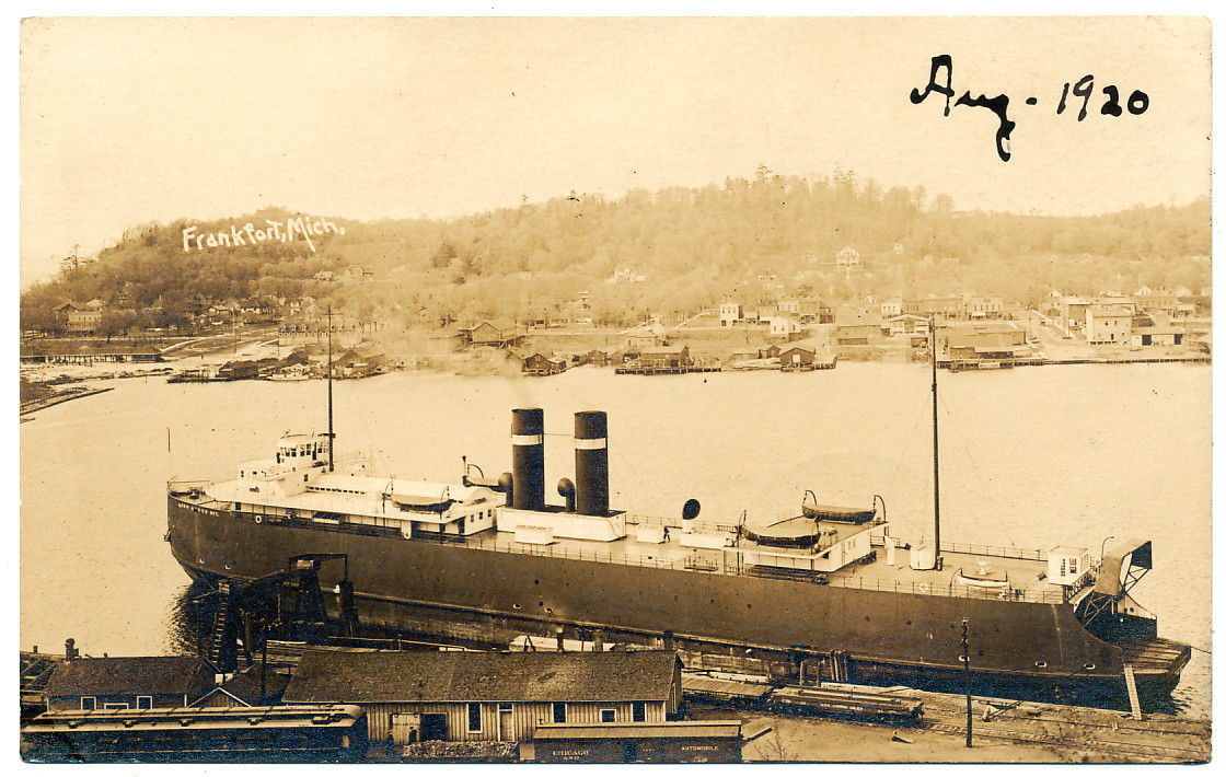 an old po shows a large ship and several small boats