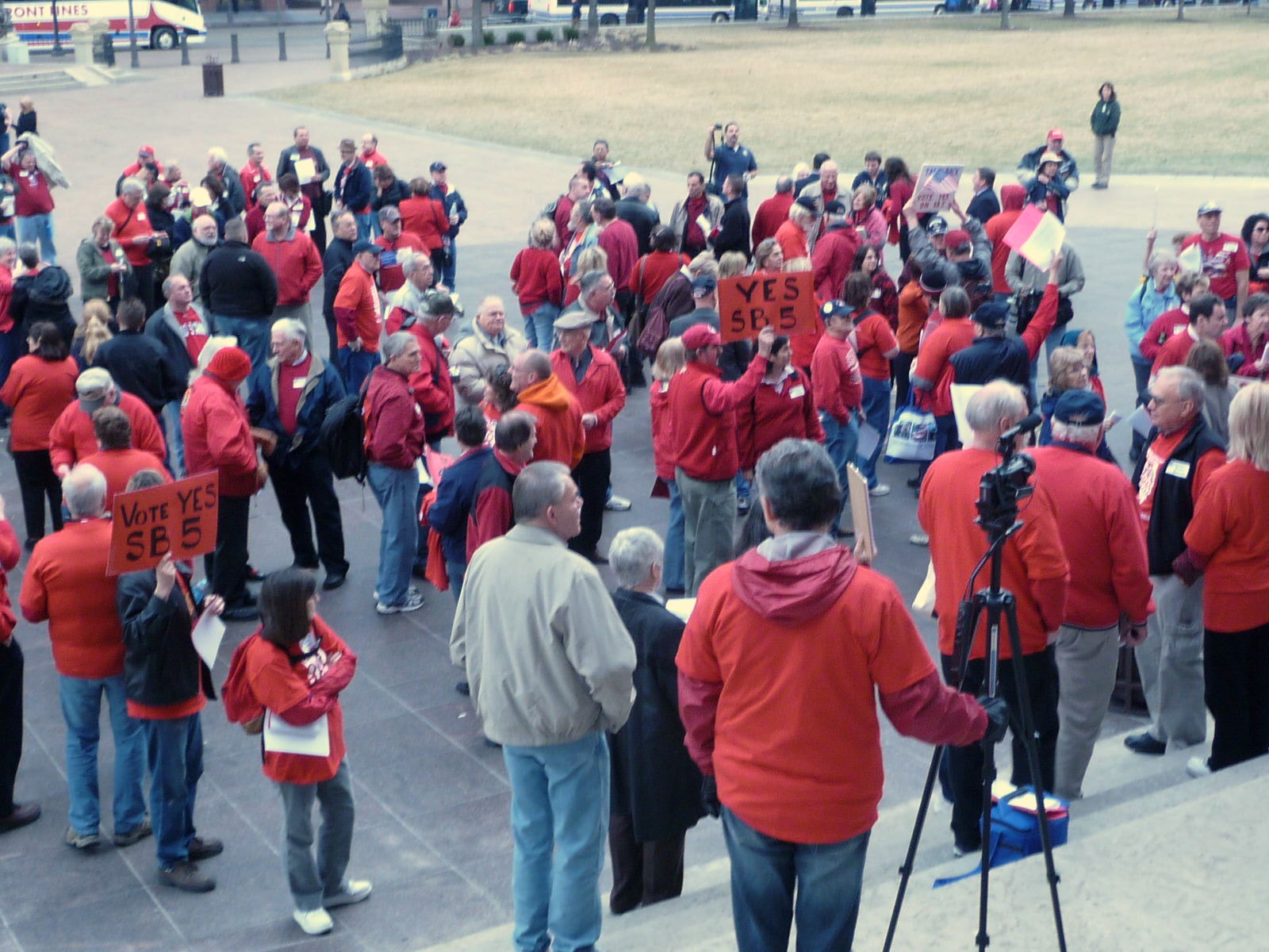 people standing in front of a group holding signs