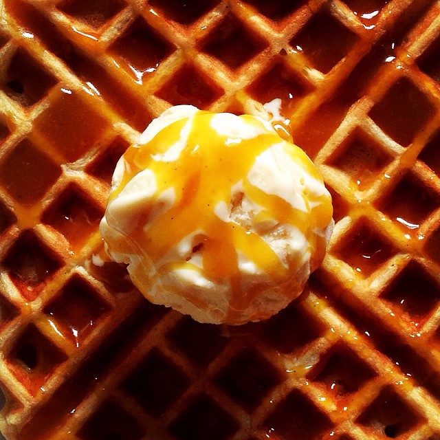 a waffle with caramel and whipped cream