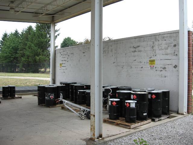 barrels in a concrete covered area on cement