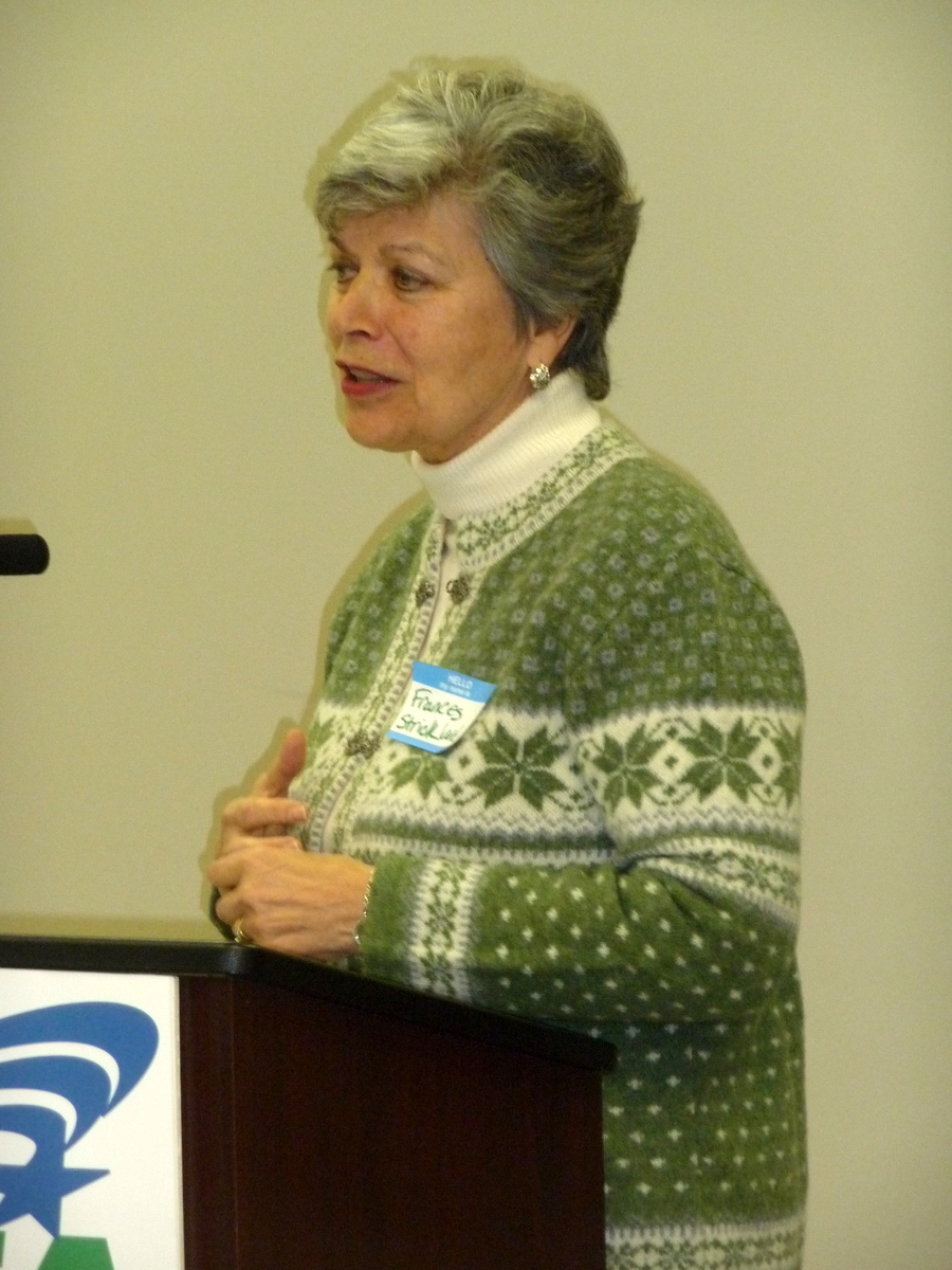 a woman giving a speech at a podium