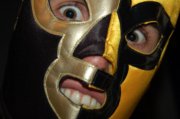 man wearing a masquerade over his mouth and nose