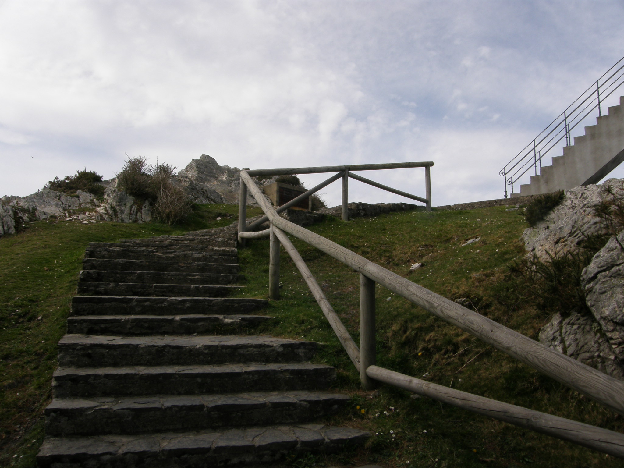 there is stairs up the hill by the stone