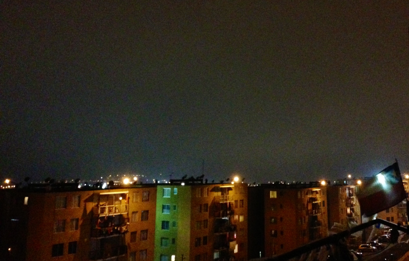 a clock tower on top of a building in a city at night