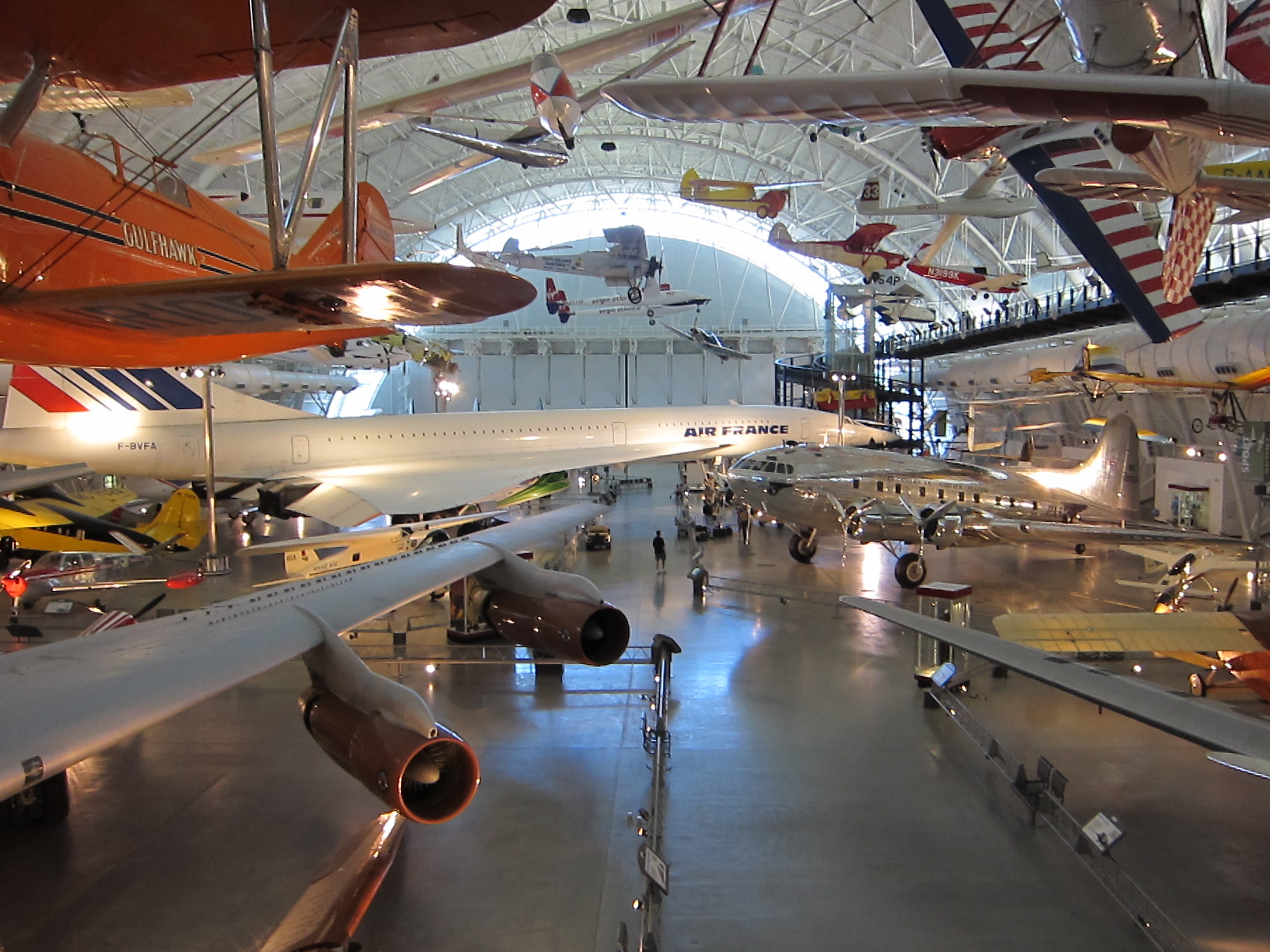 the museum is filled with antique airplanes in rows