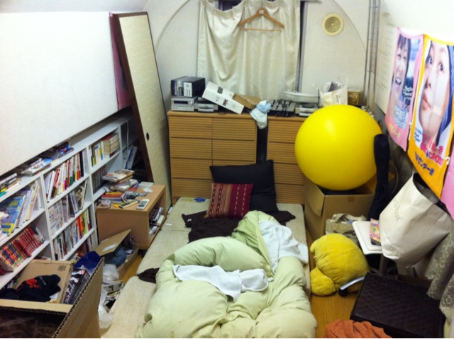 there is a messy room with a large yellow ball
