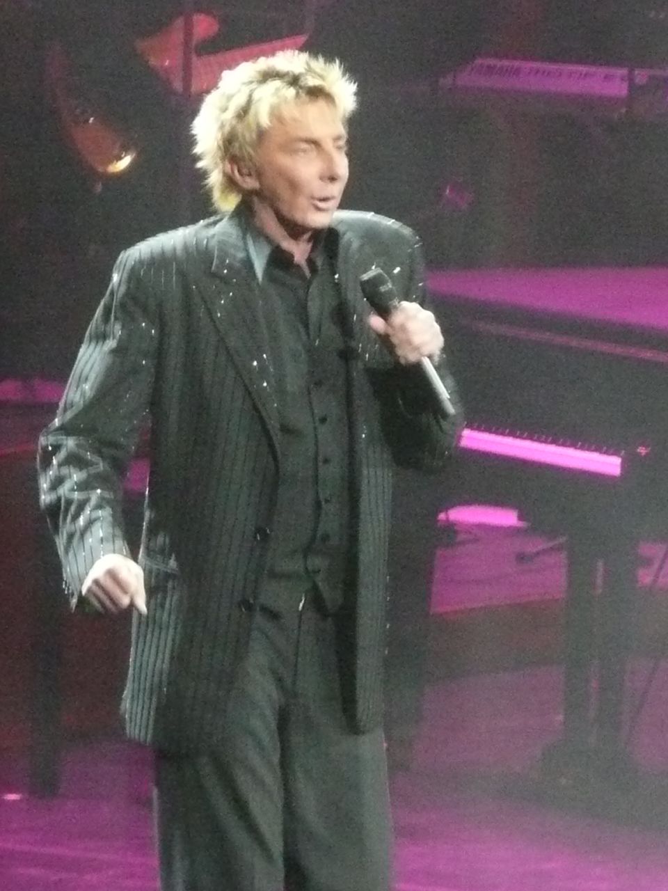 a man in a suit and tie standing on a stage