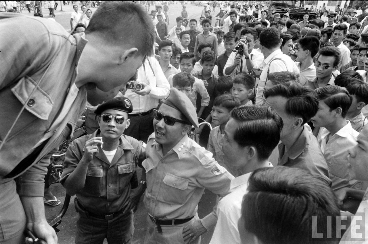 a man in uniform feeding some people