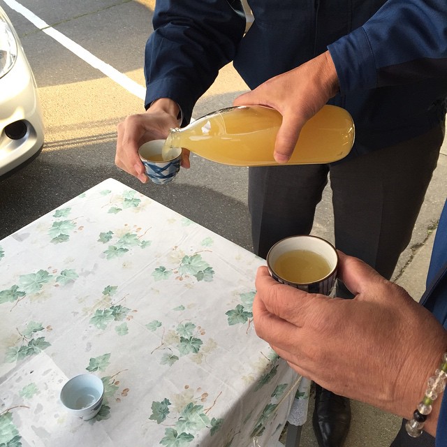 a man in a suit pours an iced beverage