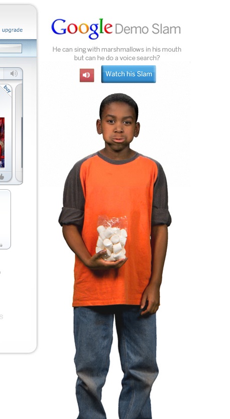 a  standing in front of a computer screen with a pile of white marshmallows in his hand
