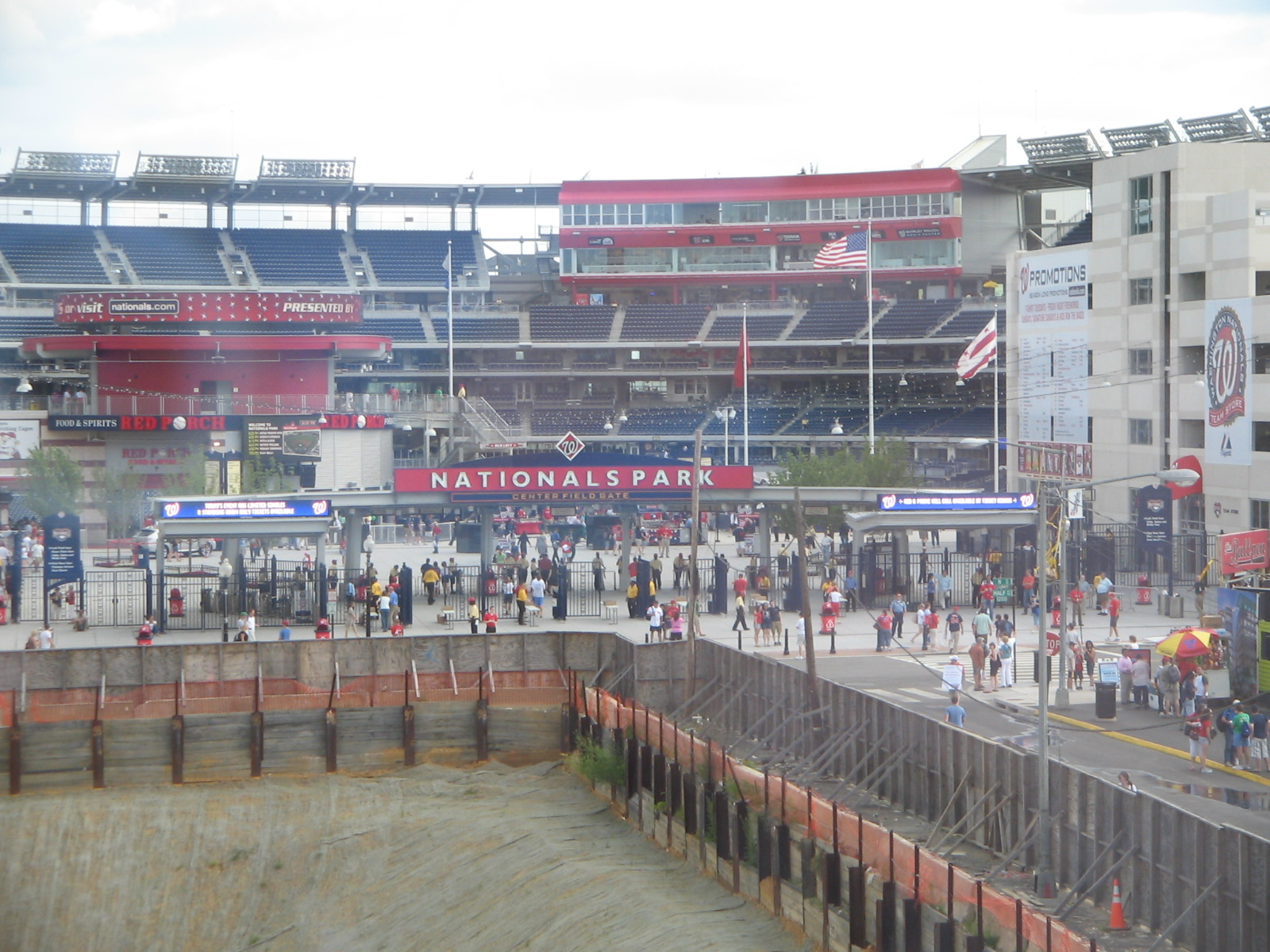 an outside view of a stadium with some fans