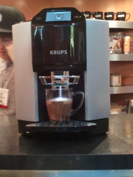 a person at a coffee shop preparing a drink