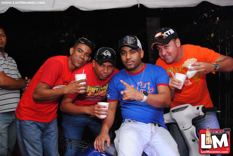 five men pose for a po with paper cups in front of them