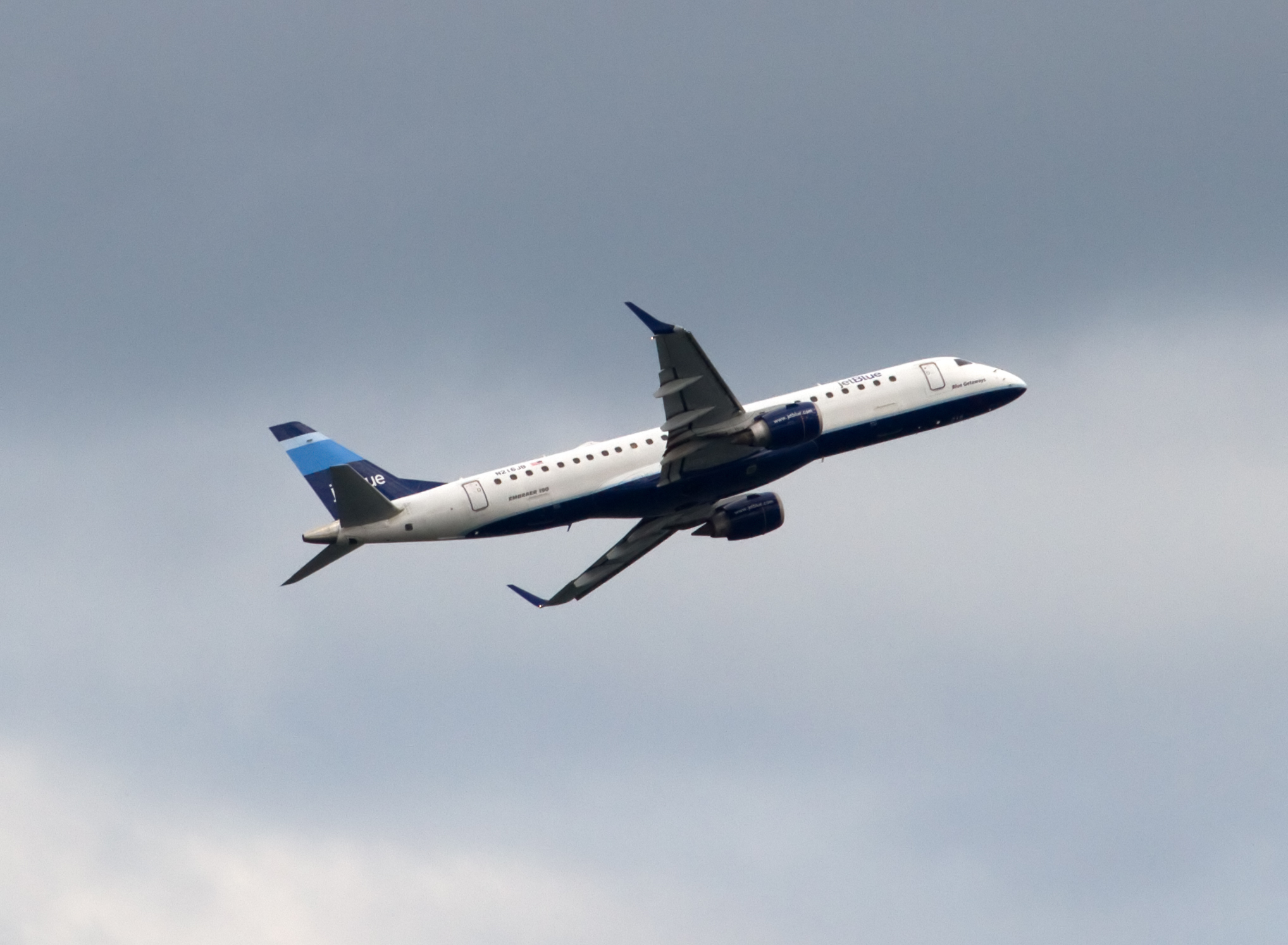 airplane flying sideways in the sky on a cloudy day